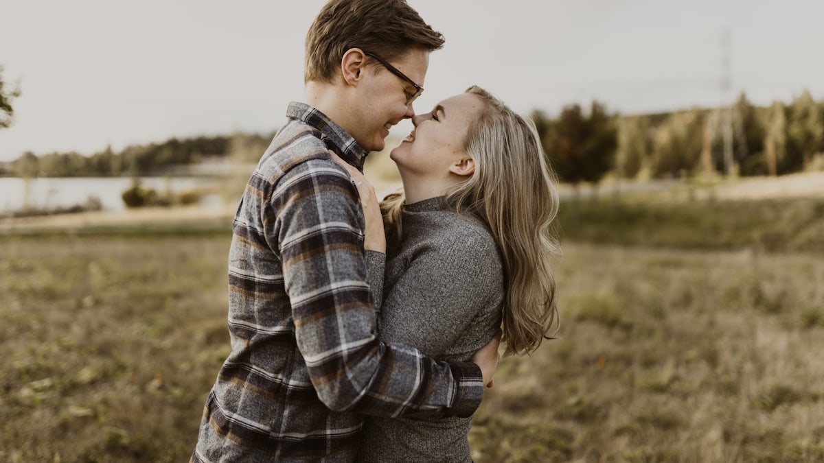man and woman kissing during daytime
